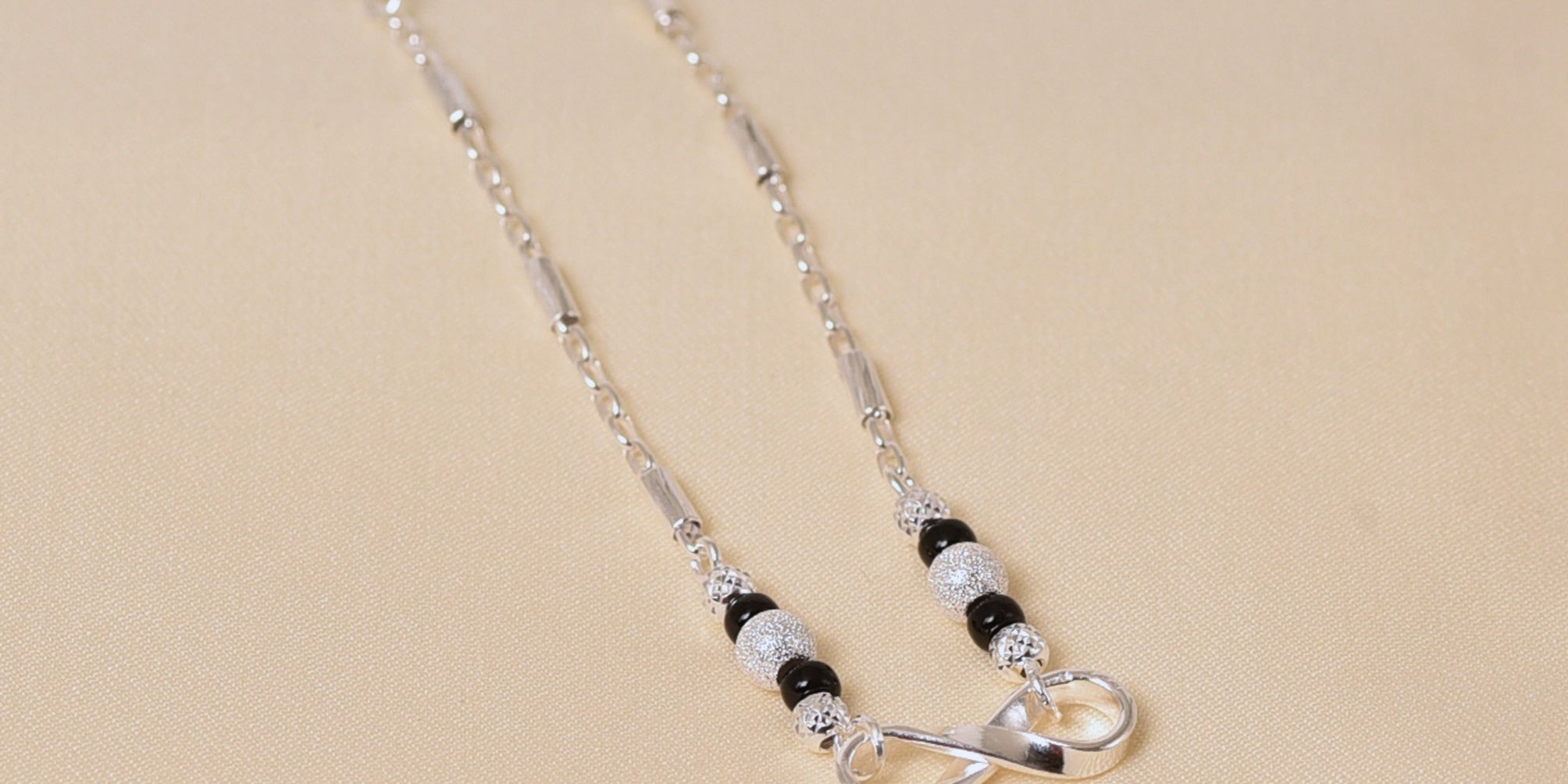 Infinity design Mangalsutra with black beads in SIlver for Women by Elyta
