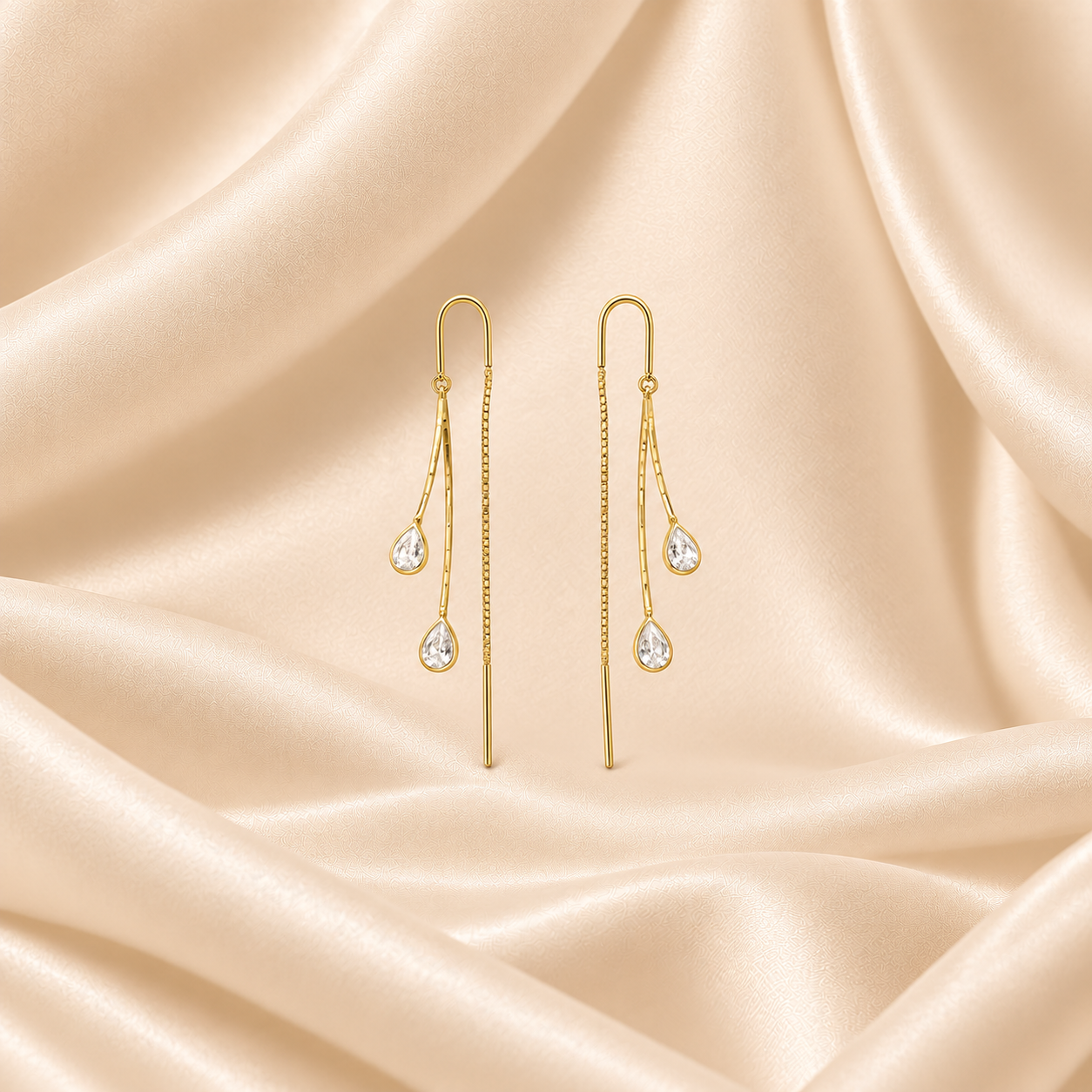 Gold_Teardrop_Earrings_on_Champagne_Satin.png