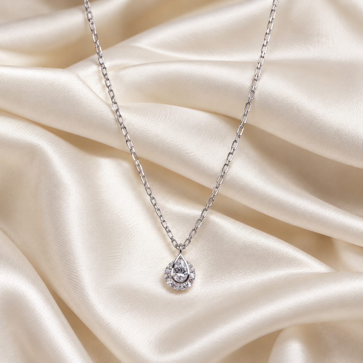 Pear-ShapedDiamondPendantonIvorySilk_a0d2fc9e-4da9-47d6-8922-3845fe2efecd.png