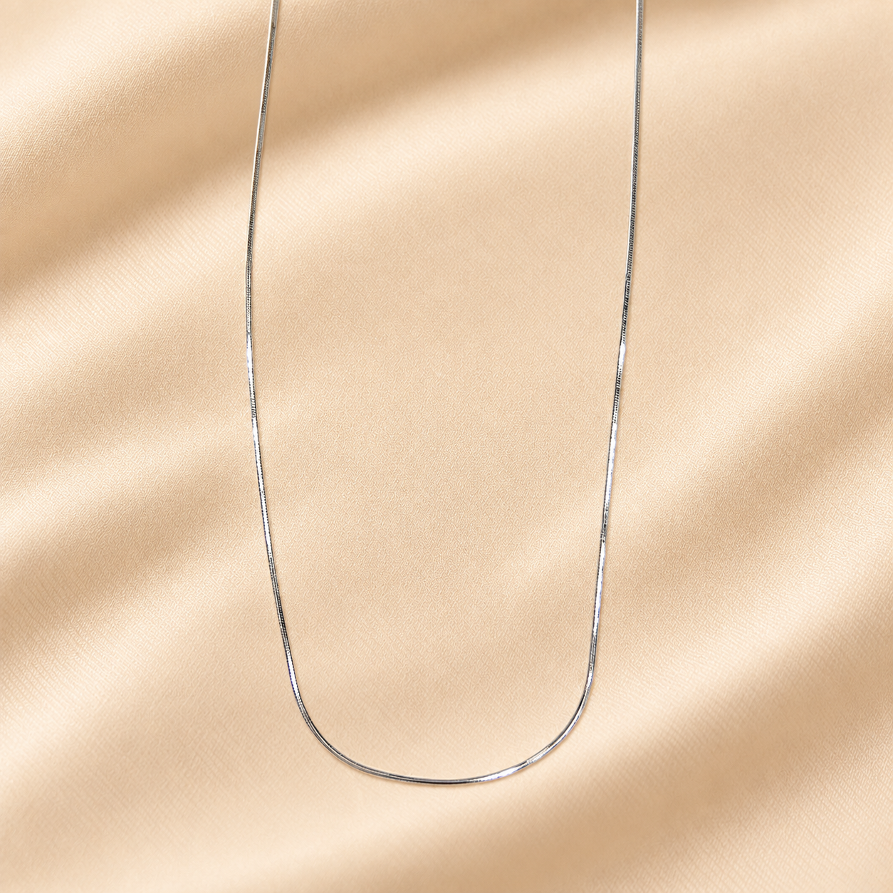 SilverSnakeChainonSatindrape_7ad4c379-ffeb-4387-a84f-26d3c2a17fde.png